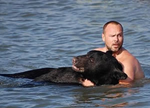 Biologist Adam Warwick saves black bear